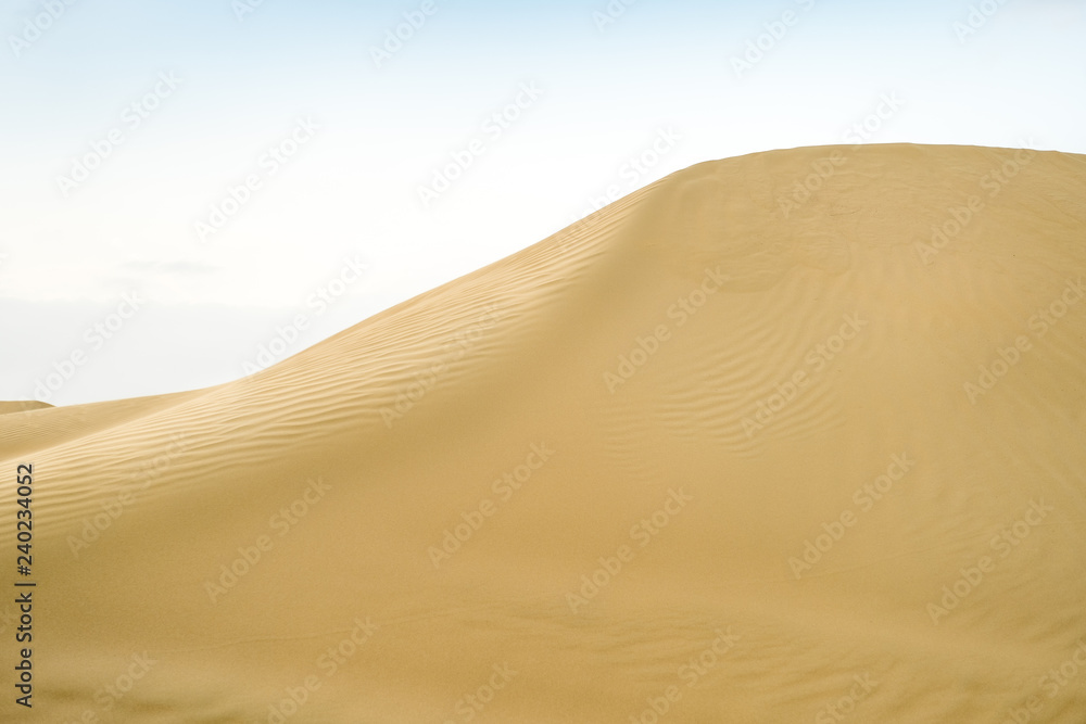 Large desert dune with a falling sand