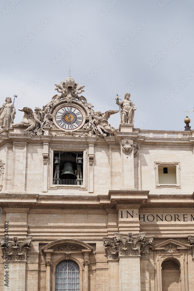 Ornate clock and, bell with statues, on St Peter's Basilica, Vatican City, Rome, Italy