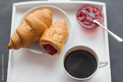 croissants with raspberry jam and black coffee