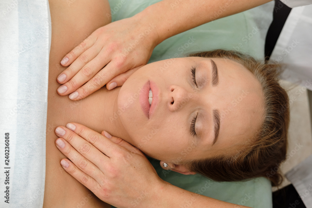 Young woman getting spa massage treatment at beauty spa salon. Cosmetologist making girl relaxing Face and head massage. Spa skin and body care. Facial beauty treatment.Cosmetology. Young woman getting spa massage treatment at beauty spa salon. Cosmetologist making girl relaxing Face and head massage. Spa skin and body care. Facial beauty treatment.Cosmetology.