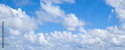 Blue sky with white cumulus clouds, daytime