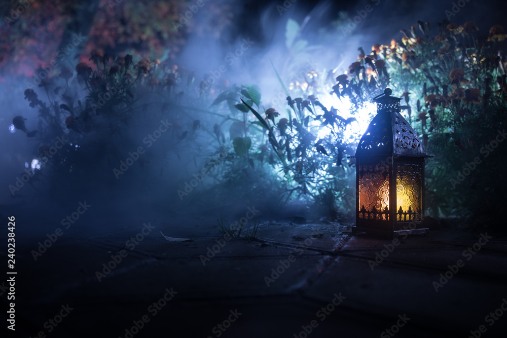 Retro style lantern at night. Beautiful colorful illuminated lamp at the balcony in the garden. Selective focus Retro style lantern at night. Beautiful colorful illuminated lamp at the balcony in the garden. Selective focus