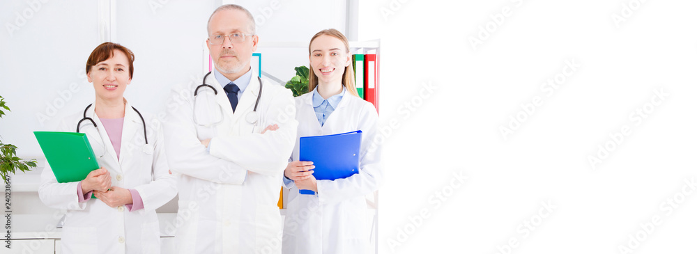 doctor posing with medical staff,nurse in office and copy space, banner of billboard doctor posing with medical staff,nurse in office and copy space, banner of billboard