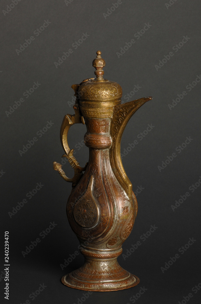 ancient oriental metal teapot on dark background. antique bronze tableware ancient oriental metal teapot on dark background. antique bronze tableware