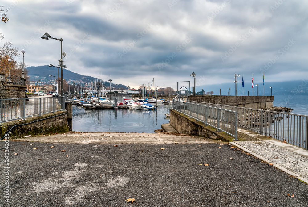 Fototapeta premium New Harbor of Luino on the Lake Maggiore in cloudy day, province of Varese, Italy
