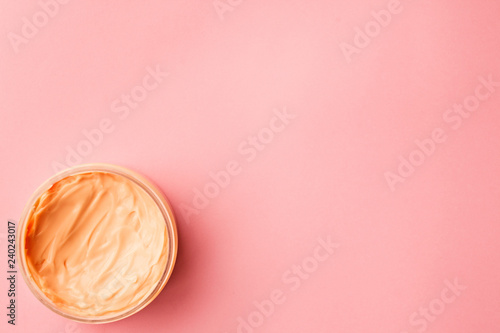 cosmetic for body, face, hair. face cream in a jar. hair mask. skin care. on a pink background. selective focus.
