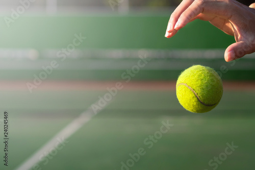 Close up hand and tennis ball on blur court background