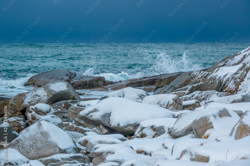 Snow-Covered Stones on the Shore of a Calm Ocean Snow-Covered Stones on the Shore of a Calm Ocean