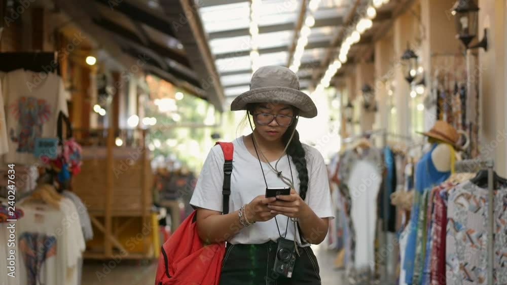 Young asian woman hand using smartphone at market. Searching internet or texting on cellphone. Young asian woman hand using smartphone at market. Searching internet or texting on cellphone.