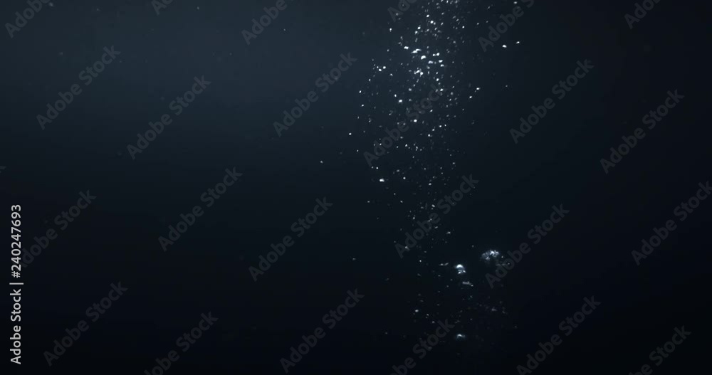 4K underwater illuminated bubbles motion. Ocean floor bubbles. Real underwater footage. Deep under sea level. Floating plankton. Marine background VFX element. Underwater bubbles mayhem
