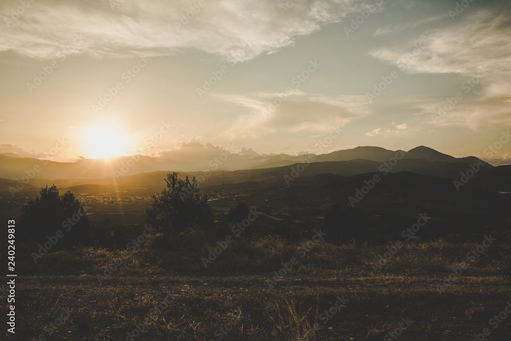 Obraz premium abstract morning sun rise unfocused scenic landscape with valley and mountain background horizon silhouettes 