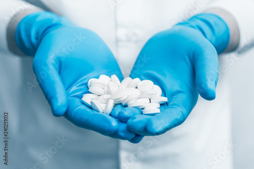 doctor holding medical drugs, pills, pills, hands with gloves