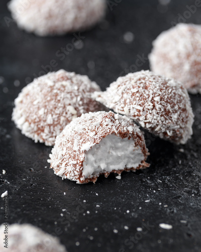 sweet mallow snowballs with chocolate coating and coconut photo