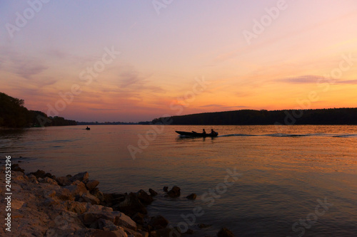 Silhouette of fishing boat at the river in sunset © Petar