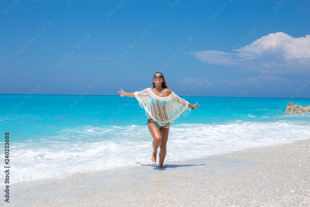 Beautiful young woman running on the beach Beautiful young woman running on the beach