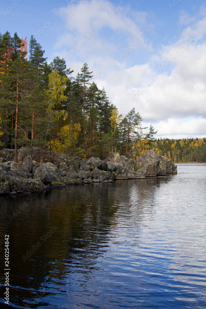 Autumn landscape with rocks, lake and forest