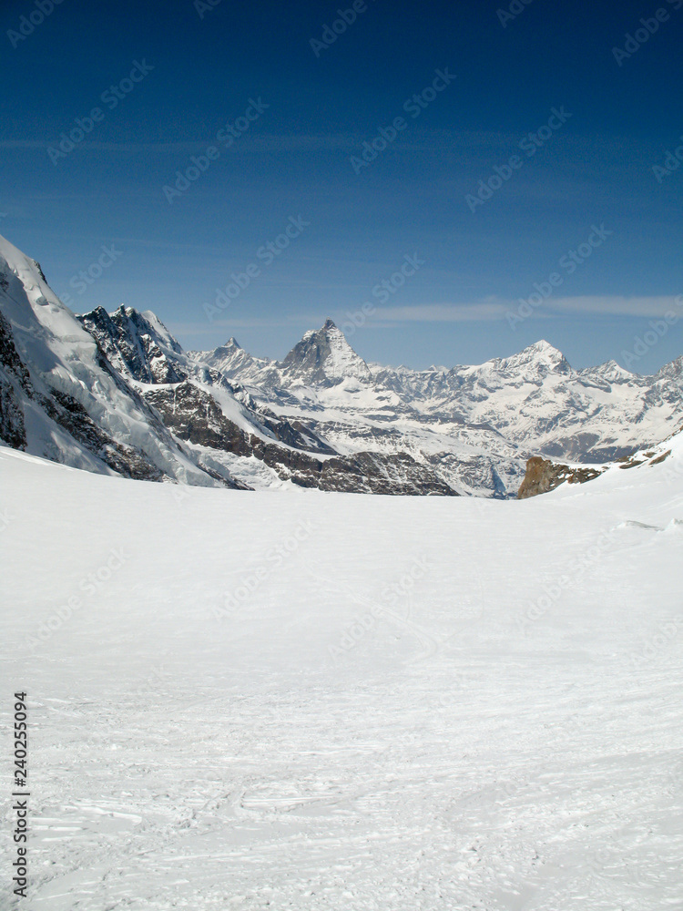 the Monte Rosa mountain range and Matterhorn mountain peak in the Swiss Alps above Zermatt in winter