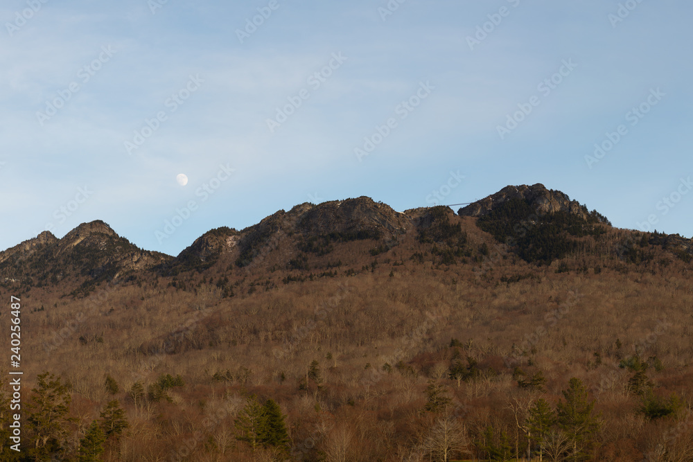 Moon rising over Grandfather Mountain and its suspension foot bridge in Linville, North Carolina near Boone.