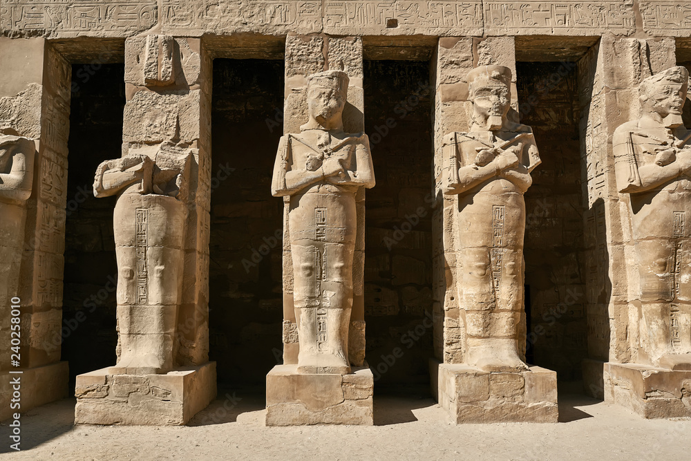 Old egyptian temple in Karnak with statues on columns