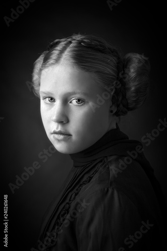 Beautiful classic young girl with alabaster skin and iconic braided ear buns wearing a pleated shirt and silk scarf.