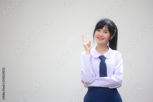 Portrait of thai high school student uniform beautiful girl pointing