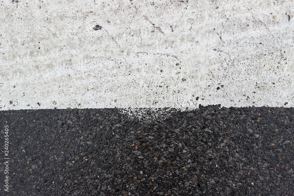 Fototapeta premium Asphalt pavement sign marking crosswalk white paint wet old surface texture detail