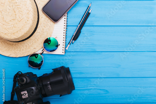 Outfit and accessories of traveler on blue background with copy space. Travel concept. Flat lay.