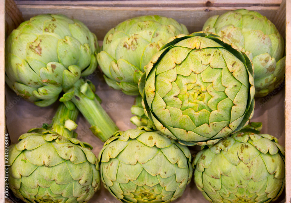 Fototapeta premium wooden box full of artichokes in french food market