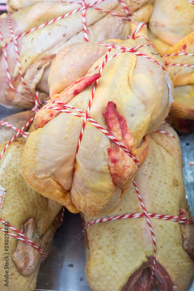 Ταπετσαρία Whole raw chicken ready to sell at a French food market