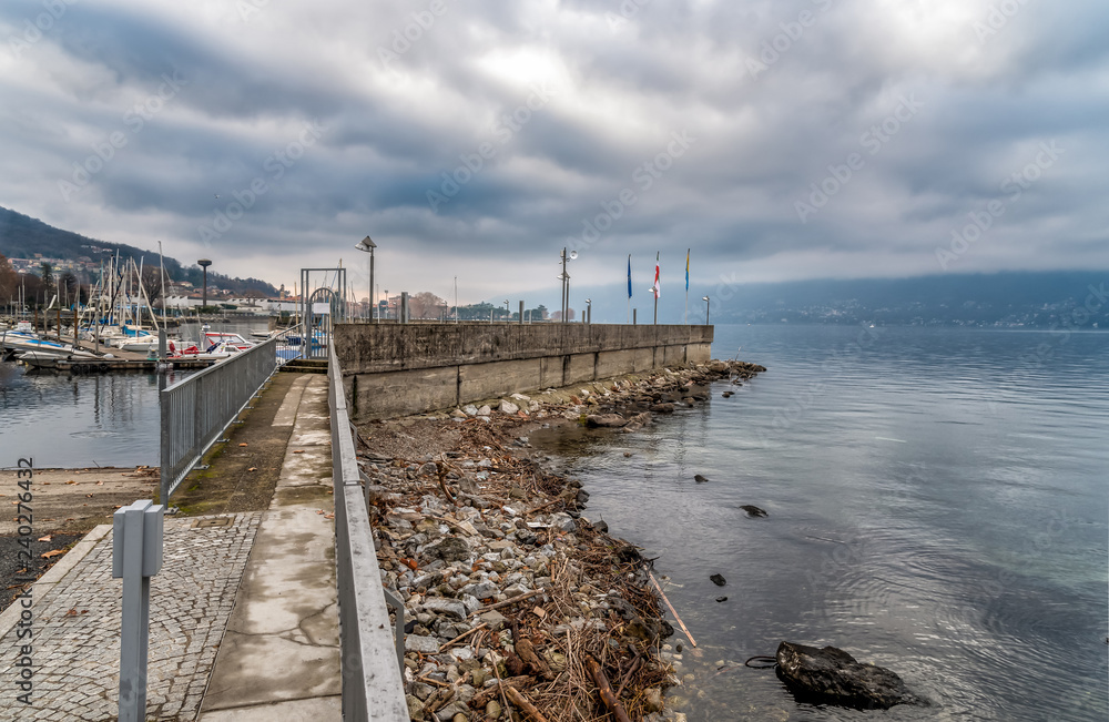 New Harbor of Luino on the Lake Maggiore in cloudy day, province of Varese, Italy