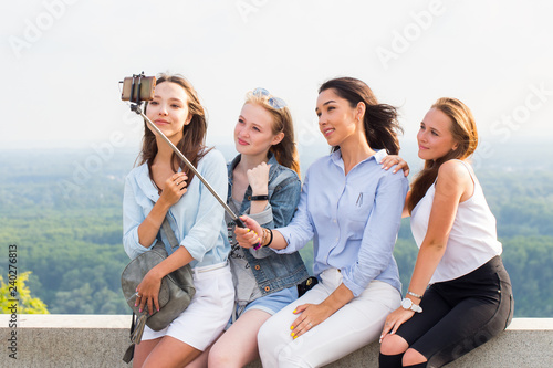 Beautiful funny girlfriends make selfies in the mountains on the background of nature. travel, summer, weekend, walk