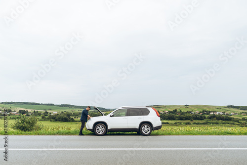 man stand near broken car with opened hood. emergency service © phpetrunina14