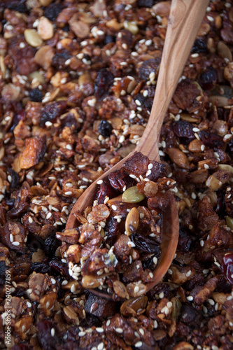 Homemade granola in pan and in a wooden spoon