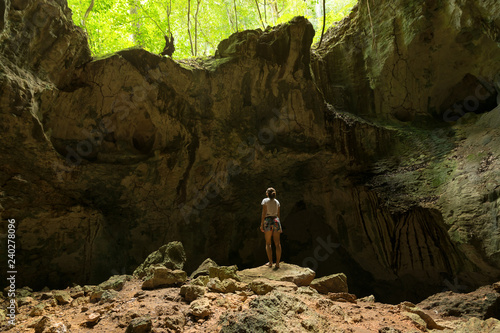 Young woman explorer observing ancient caribbean cave. Los Haitises natonal park in Dominican Republic. photo