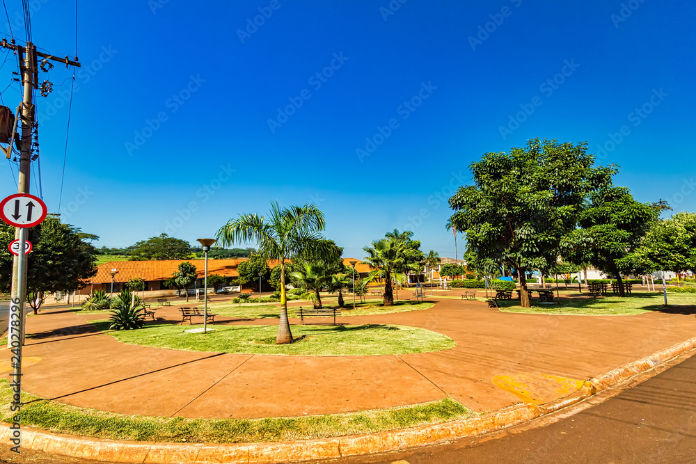 Obraz premium Square with trees in sunny day in the city of Dumont in the interior of Sao Paulo, Brazil