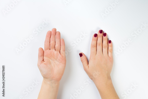 Top view photo of woman's hands with dark manicure