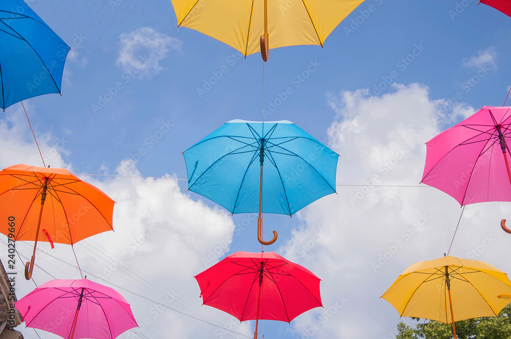 Colorful umbrellas against the sky in city settings
