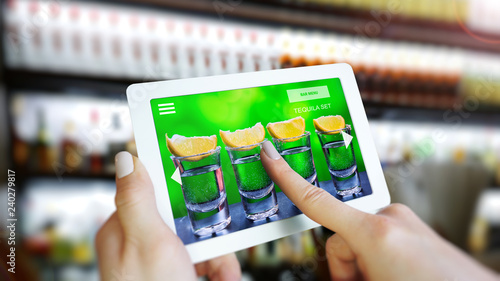 Customer use AR application to order drink at the bar, Hand touching interface