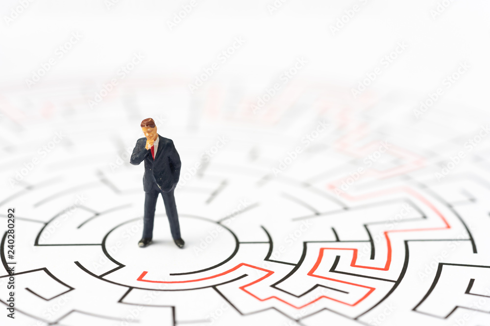 Miniature people, businessman in the labyrinth or maze figuring out the way out. Business concept, finding solution, strategic, and business opportunity. Miniature people, businessman in the labyrinth or maze figuring out the way out. Business concept, finding solution, strategic, and business opportunity.