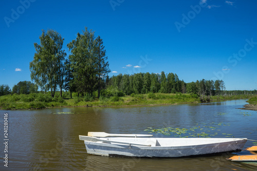 Boat on river at beautiful summer day.