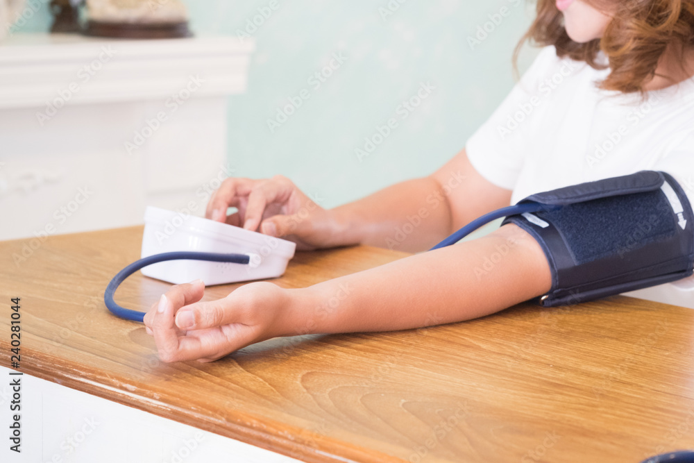 Woman measures her blood pressure. Health care and medical equipment concept. Woman measures her blood pressure. Health care and medical equipment concept.