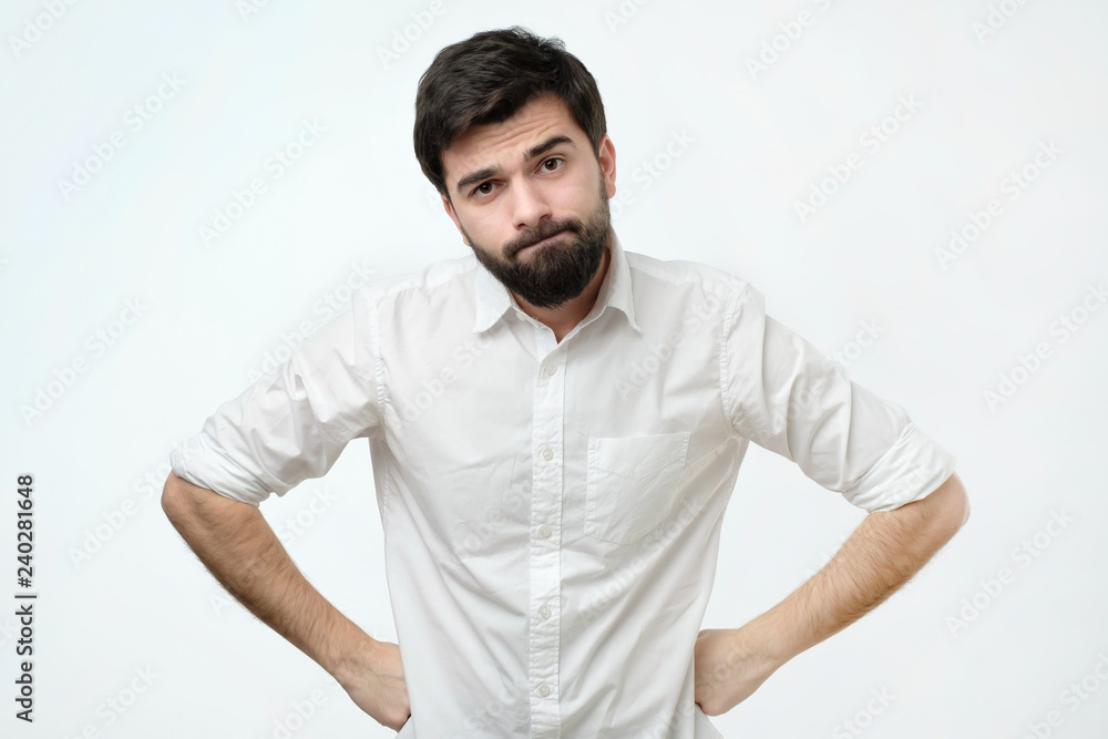 Man is offended because his girlfriend forgot about his birthday. Annoyed and angry funny mature caucasian man with beard, frowning and sulking from disappointment, holding hands on hips Man is offended because his girlfriend forgot about his birthday. Annoyed and angry funny mature caucasian man with beard, frowning and sulking from disappointment, holding hands on hips