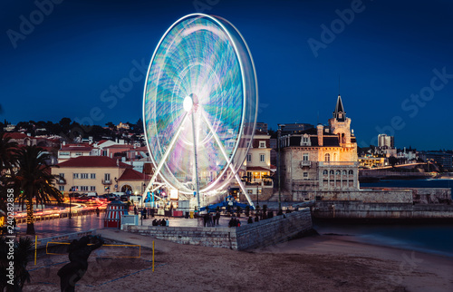 Long exposure of giant ferris wheel entertaining locals and tourists at Cascais, Portugal