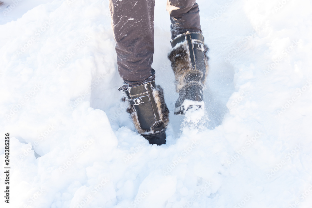 a walk in the snow. closeup of winter shoes a walk in the snow. closeup of winter shoes