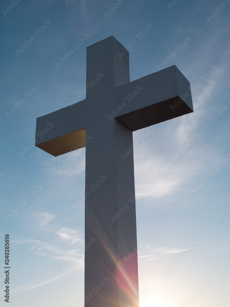 White cross with god beam ray of light at sunset
