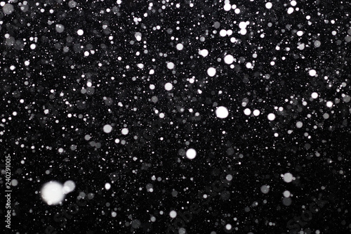 Snowfall on black background