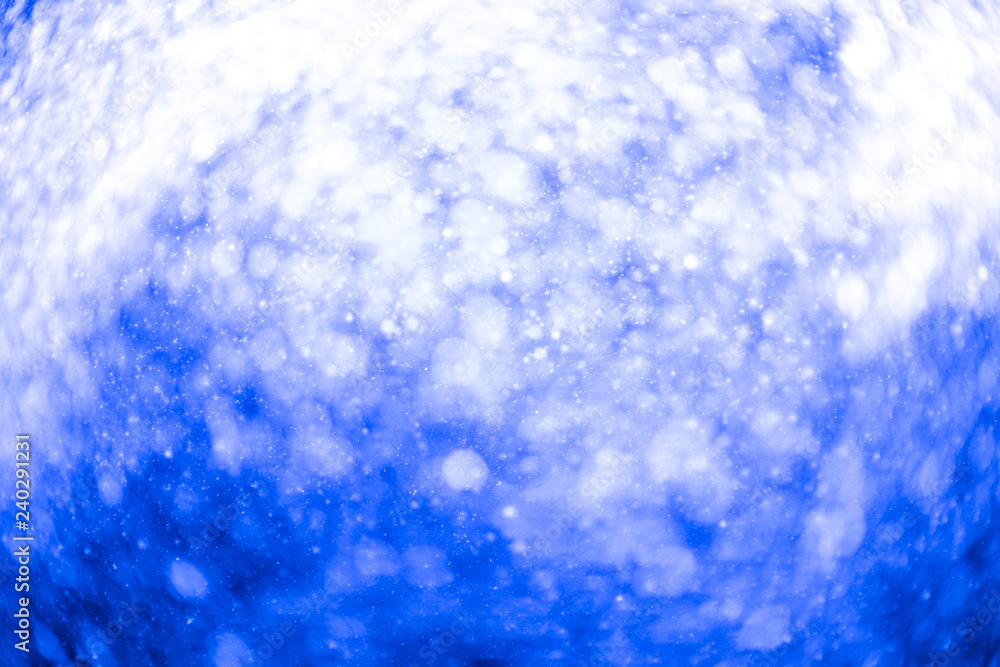 Snowfall bokeh on blue background