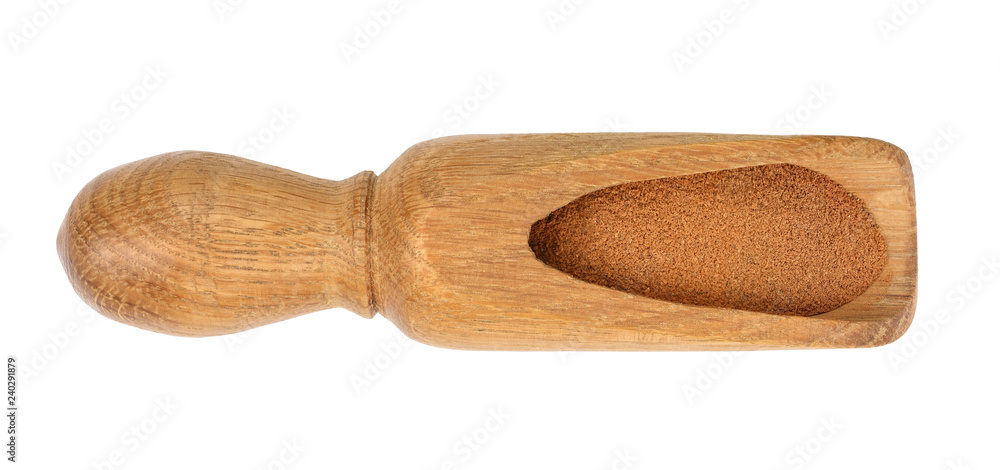 Cinnamon powder in wooden scoop isolated on white background. Top view