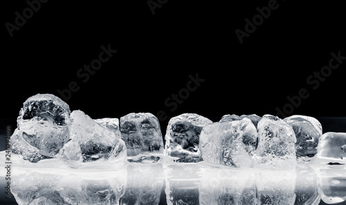 Pieces of crushed ice cubes on black background.