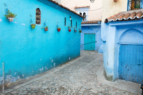 blue narrow street with vases on the wall in blue city Chefchaouen in Morocco © sergejson